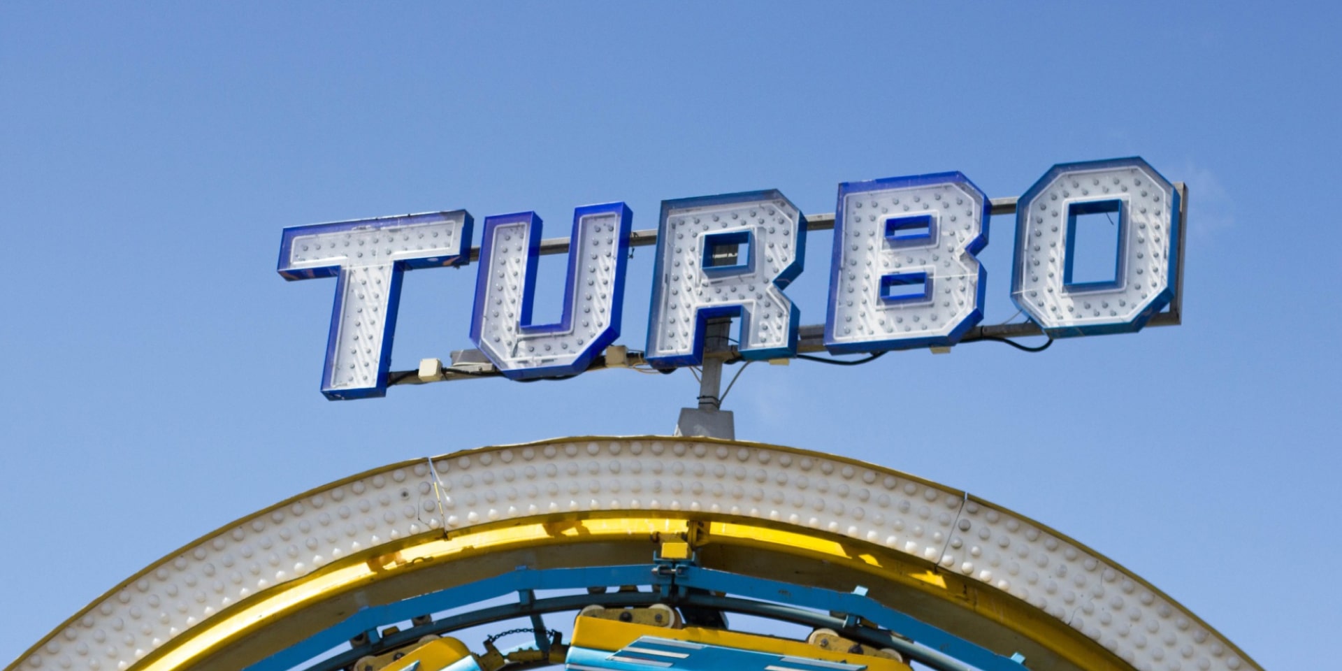 An older sign on top of a rollercoaster ride stating: 'Turbo'