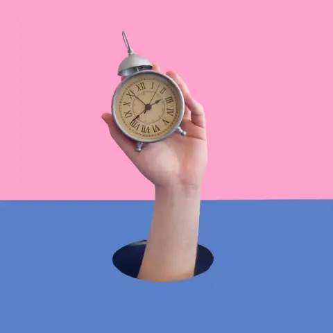 A hand holding a clock on a vibrant pink & blue background