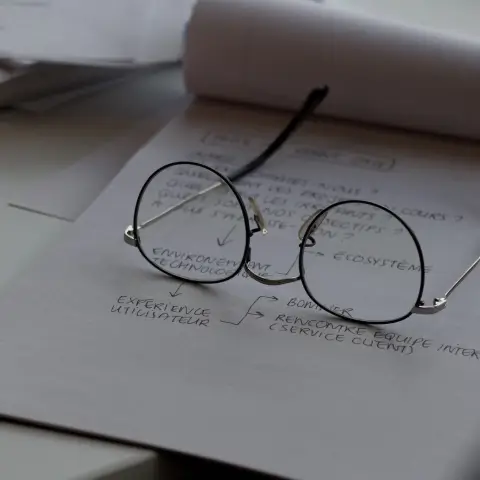 A pair of glasses on top of a drawn flowchart