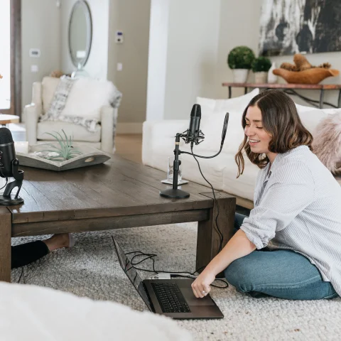 Podcaster sitting on the floor recording podcast